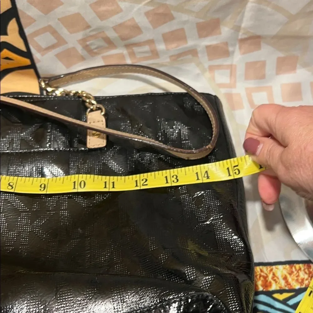 Michael Kors Jet Set Chain Tote in black patent leather with gold hardware.